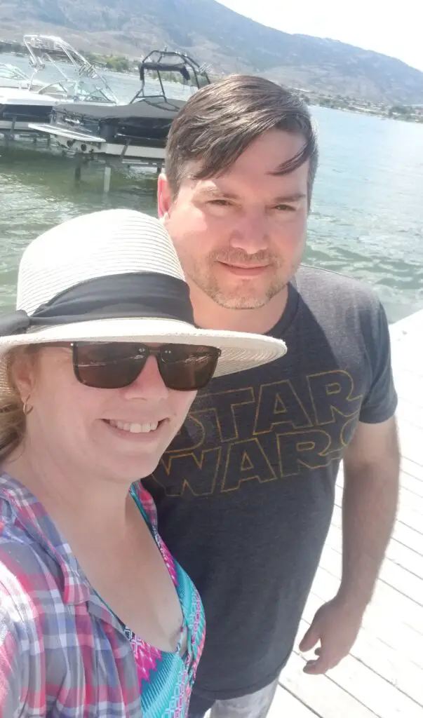 Stacey and Gerald standing on a dock taking a selfie